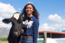 Alexis Cooper Miss USU with a cow
