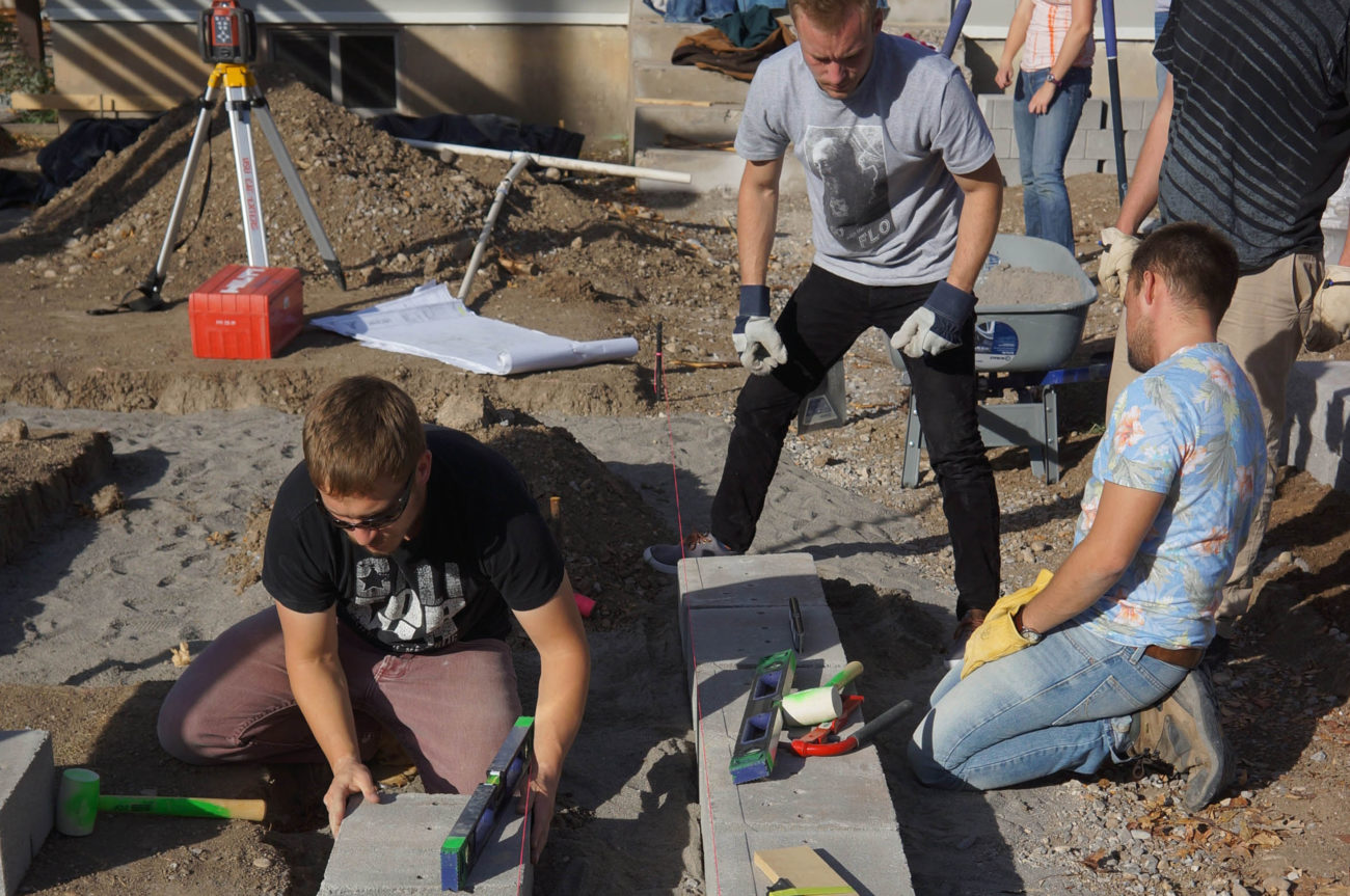Students work on the cement base for a project