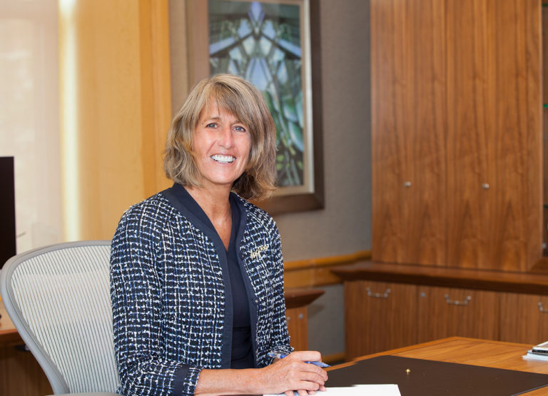 President Noelle Cockett seated at her desk