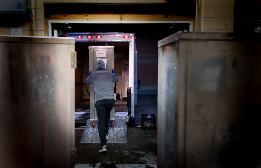 Student worker loading pastries on a truck for 6 a.m. deliveries across campus.