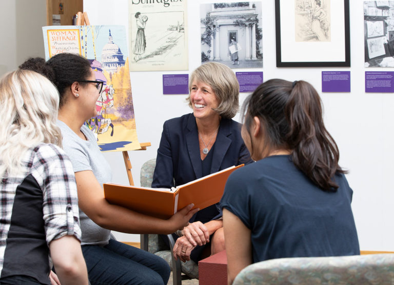 president Noelle Cockett talks with students at the Anthropology Museum.