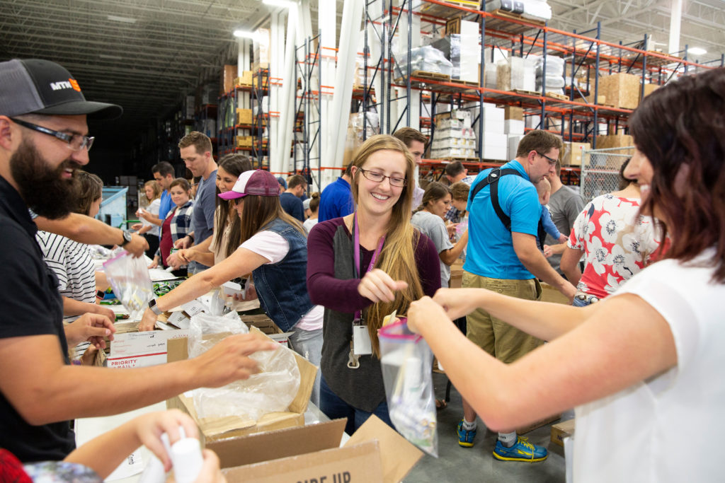 employees at Malouf assemble hygiene kits as part of the company's focus on volunteerism.