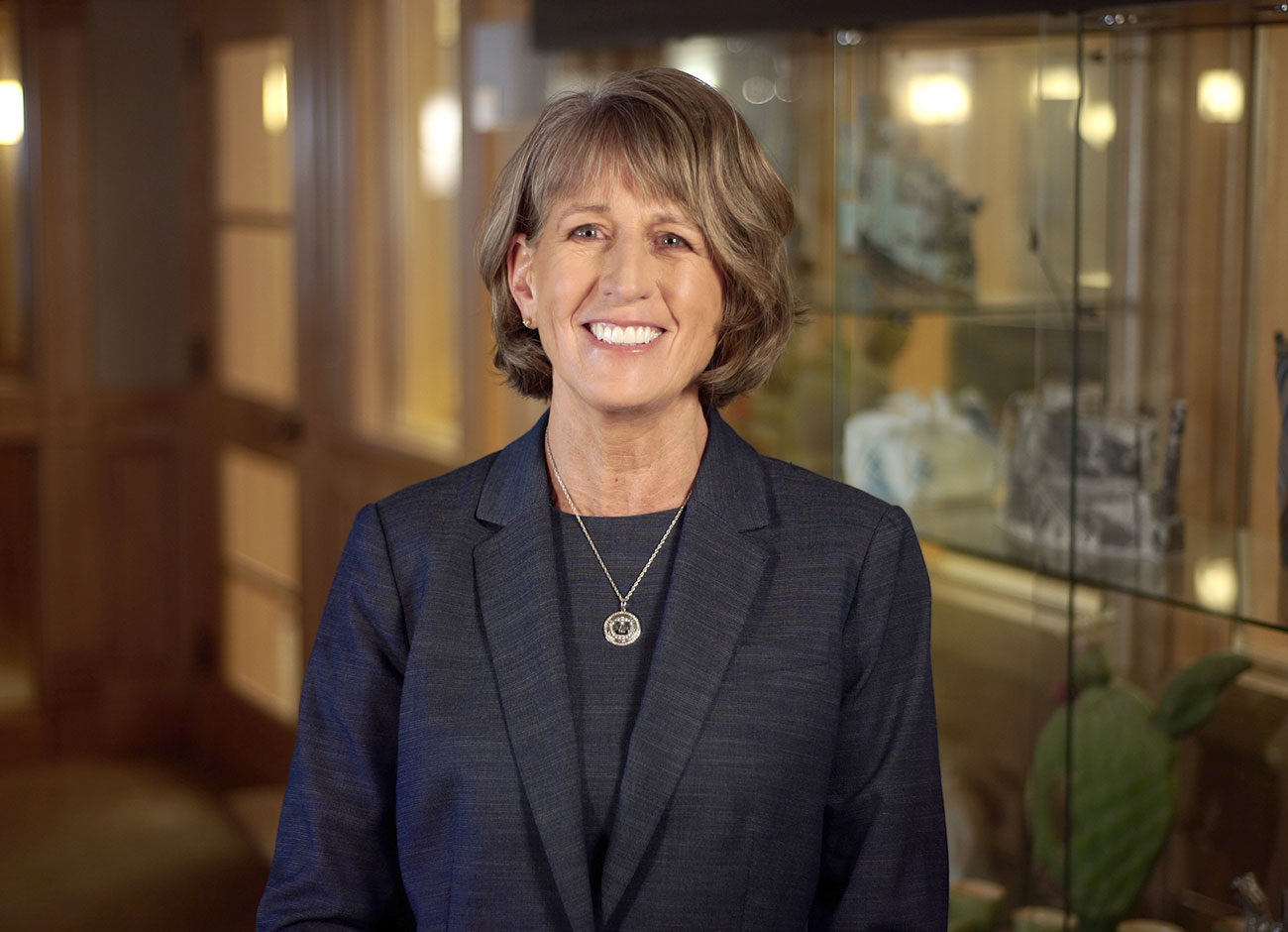 A smiling USU President Noelle Cockett in her office.