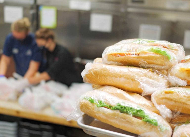 a stack of sandwiches wrapped in plastic wrap