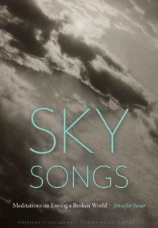 a black and white photo of a sun behind clouds with words: Sky Songs - Meditations on Loving a Broken World by Jennifer Sinor