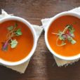 two cups of tomato soup in white bowls
