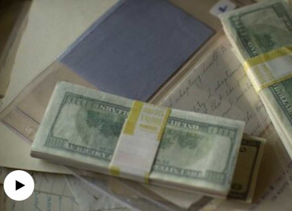a pile of money on top of a historical document. with pull quote: "Everything felt kind of high stakes, as far as its related to church history and American history. And then the lives that were senselessly taken. It’s just a fascinating, fascinating story.” - Director Jared Hess