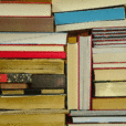 a stack of books piled horizontally and vertically