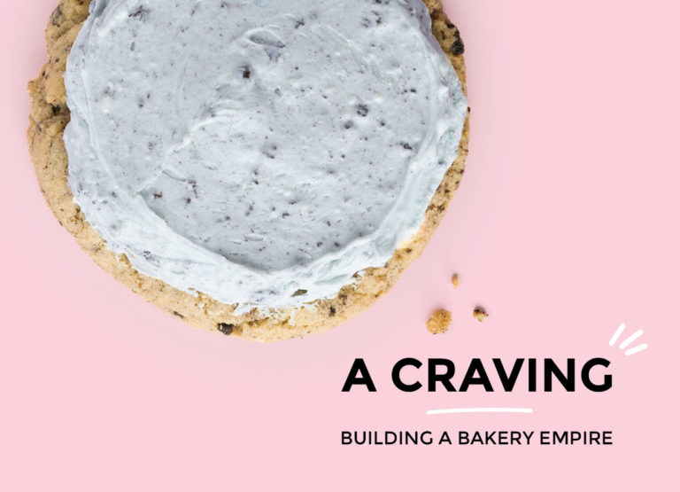 an enticing cookie with a spread of pale blue frosting sits a pink background with the title "A Craving: Building a Bakery Empire"