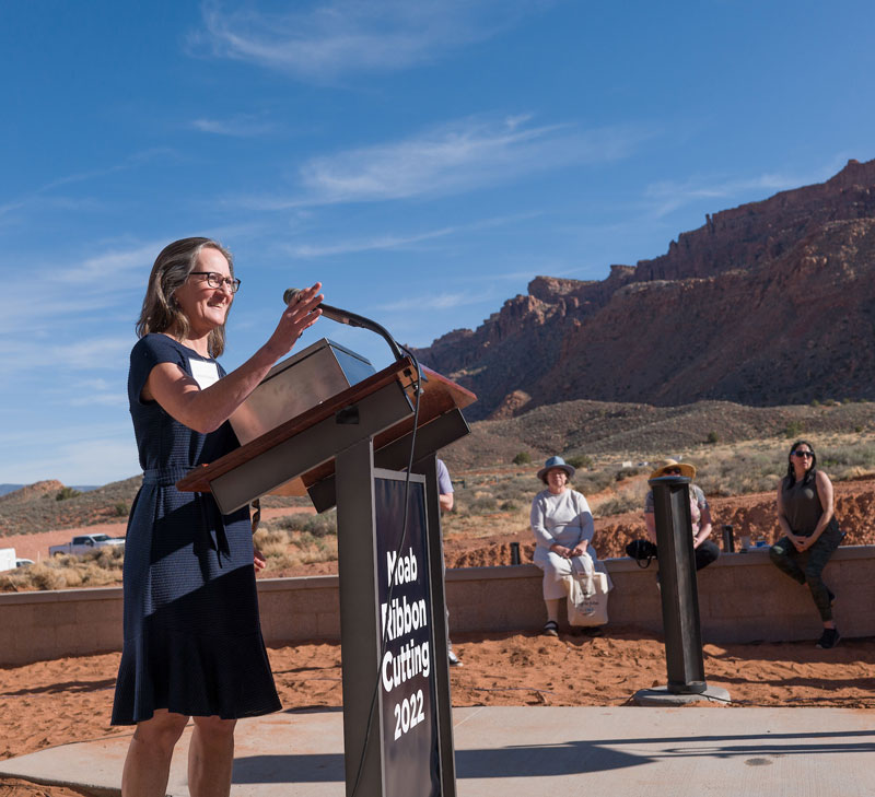 Woman giving a speech in southern Utah at a ribbon cutting ceremony