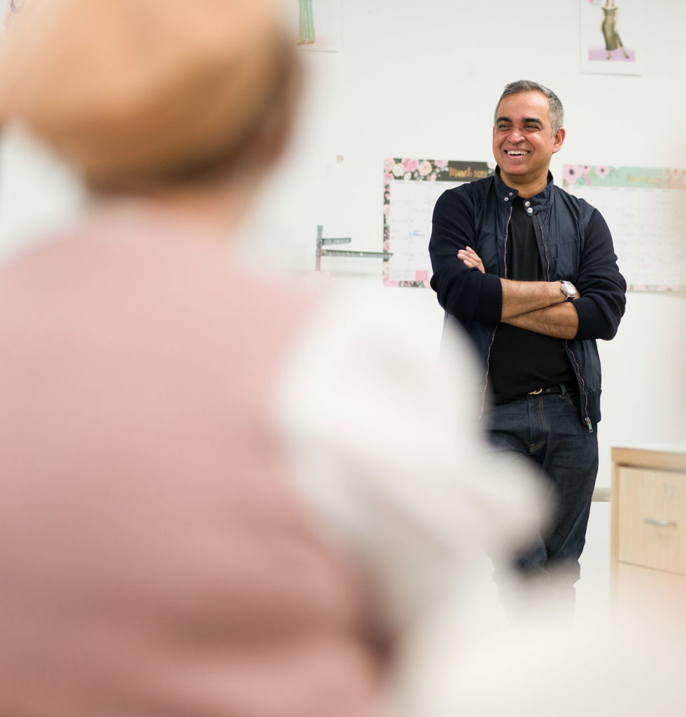 Bibhu Mohapatra smiling in front of students.