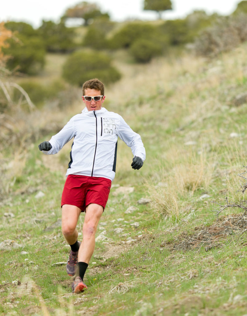 michael mcknight, an ultrarunner, runs downhill in his iconic glasses