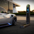 an electric vehicle is plugged into a station at dusk