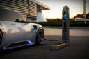 an electric vehicle is plugged into a station at dusk