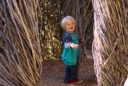 a little boy walks through the temporary sculpture A Restless Spell