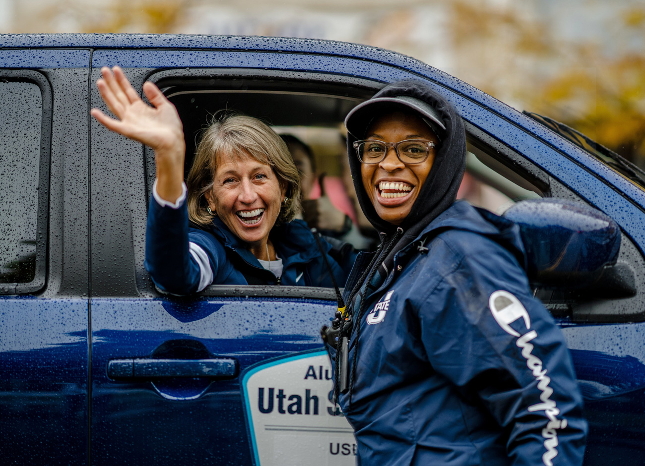 USU President Noelle Cockett waves from a pickup during the homecoming parade