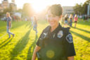 a female police officer smiles on the Quad with students in the background
