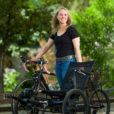 USU alum Christine Maughan poses with her recumbent trike with electric assist.