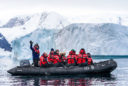 Members of the nonprofit group Walking Softer travel around the Antarctic Peninsula on a Zodiac raft to view scenery and wildlife as part of the inaugural Walking Softer Leadership Summit.