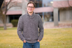 USU assistant professor and researcher in the Department of Human Development and Family Studies, Andy Harris, poses for a portrait in front of USU's Ephraim Utah campus.