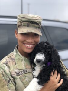 Veteran Markie Madden poses with her dog. 
