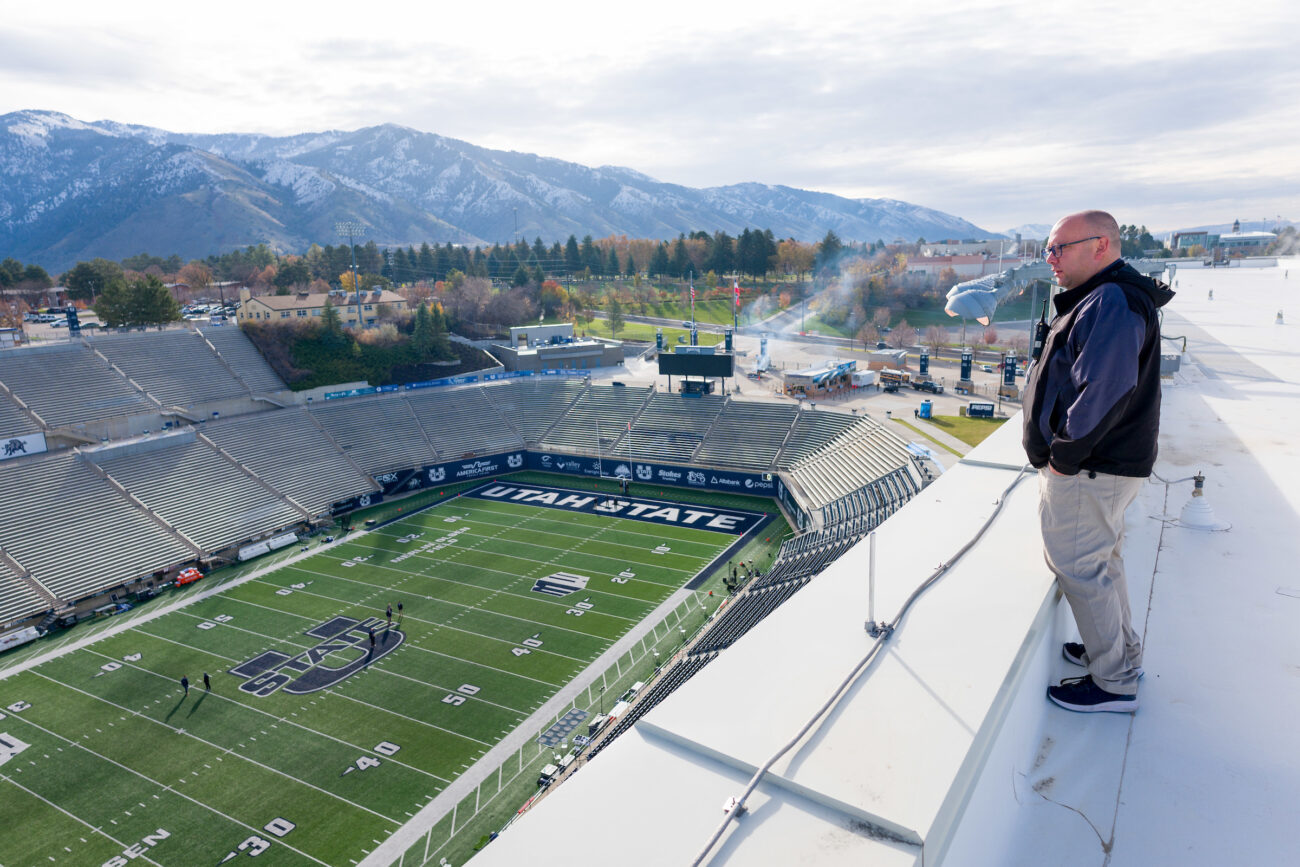 Brandon Hansen, USU's associate director for events and guest services stands atop Maverik Stadium's West Stadium Complex as he takes in the scene of the Aggies upcoming football game.