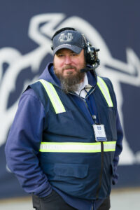 Dustin Moore, a former military policeman, roams the sidelines during a USU football game as a member of the Guest Services team.
