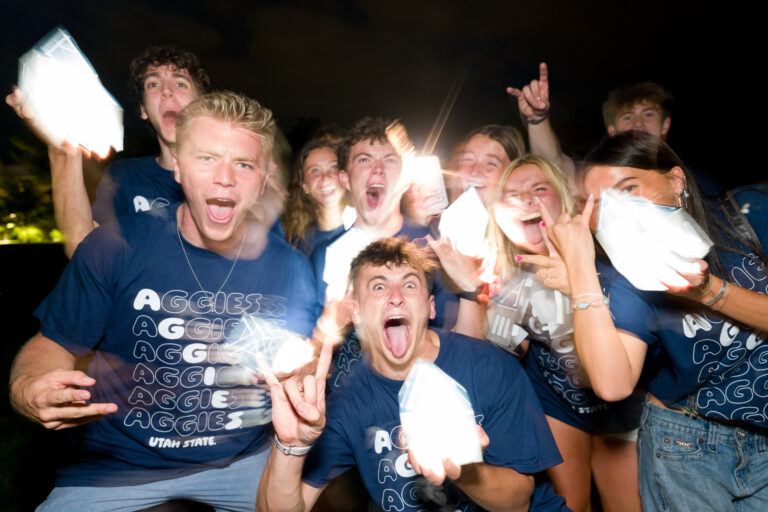 USU students hold lanterns during the university's Luminary event during Weeks of Welcome.