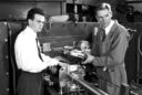 A historical photo showing two men celebrating the discovery of machine-made mesons in the 1940s.